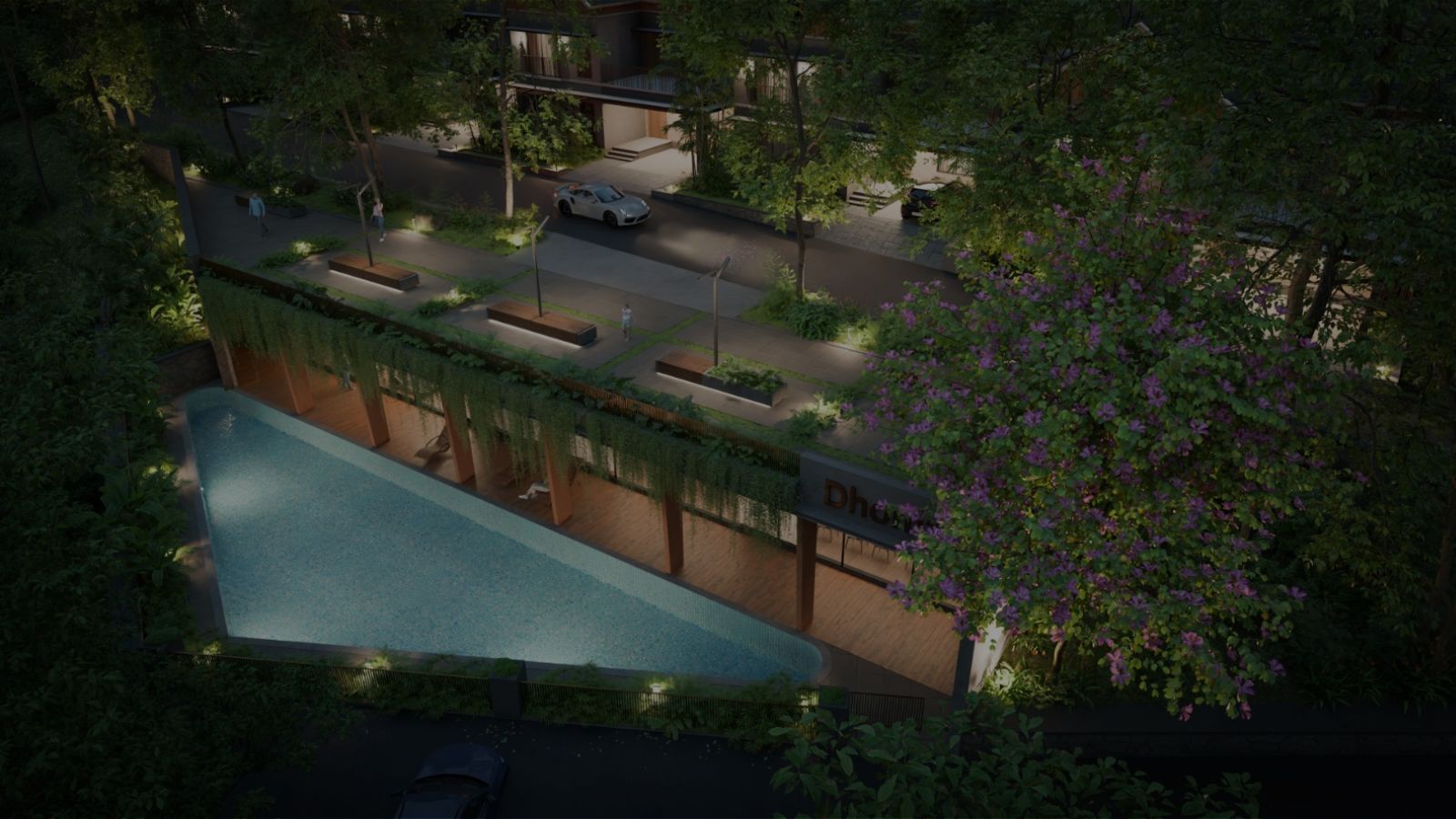 Luxury gated villas in Malappuram with a landscaped swimming pool, greenery, and modern community amenities at night.