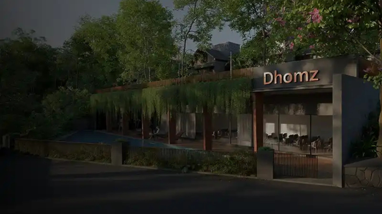 Entrance view of a premium gated villa community by Dhomz, featuring contemporary architecture, landscaped greenery, elegant lighting, and a welcoming clubhouse.